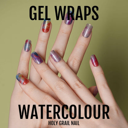 Rainbow watercolour gel nail wraps on hands with blended painterly finish