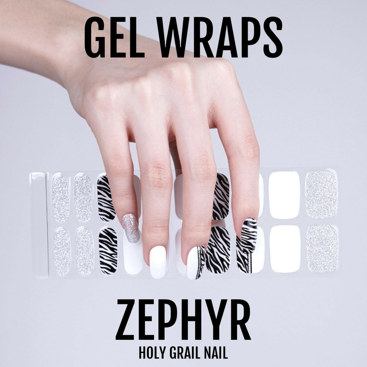 Black and white zebra print gel nail wraps on hand with glitter accents