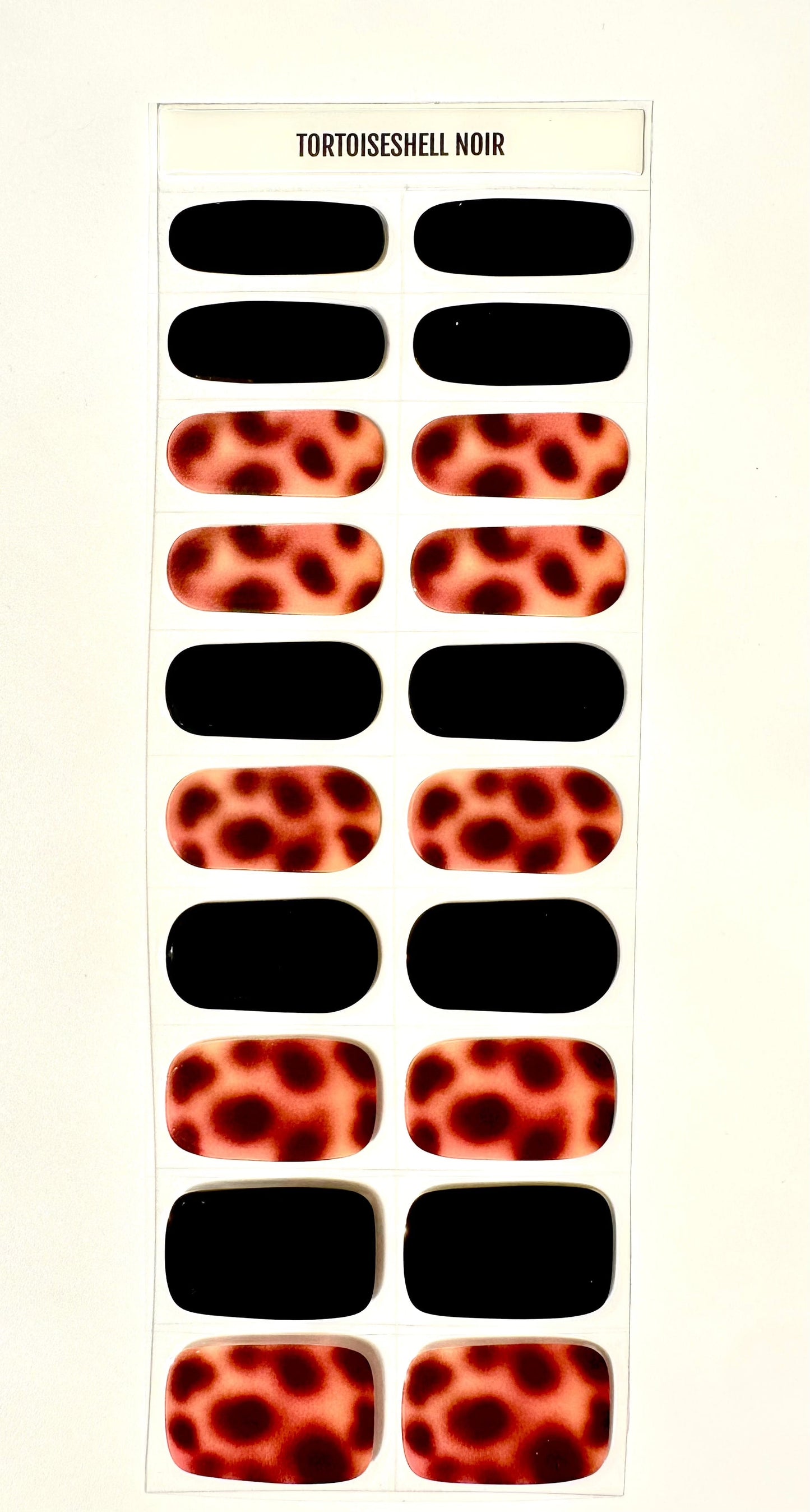 Tortoiseshell noir gel nail wraps with black and brown animal print pattern