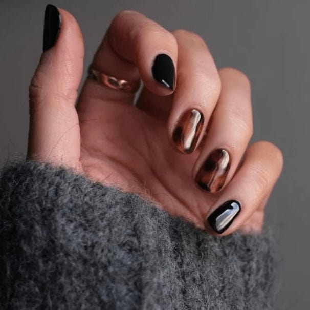 Tortoiseshell nail art in brown and black animal print on hand