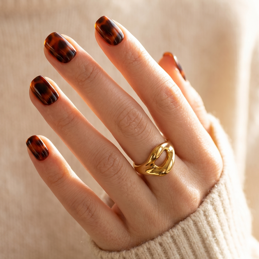 Soft gel press-on nails in glossy brown tortoiseshell print, extra short natural shape